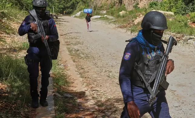 Police officers patrol the area near the Saint-Helene orphanage in the Kenscoff neighborhood of Port-au-Prince, Haiti, Monday, Aug. 4, 2025. (AP Photo/Odelyn Joseph)