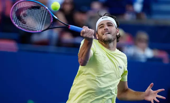 Taylor Fritz, of the United States, returns a forehand to Gabriel Diallo, of Canada, during their match at the National Bank Open men's tennis tournament in Toronto, Friday Aug. 1, 2025. (Frank Gunn/The Canadian Press via AP)