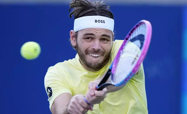 Taylor Fritz, of the United States, returns with a backhand to Gabriel Diallo, of Canada, during their match at the National Bank Open men's tennis tournament in Toronto, Friday, Aug. 1, 2025. (Frank Gunn/The Canadian Press via AP)
