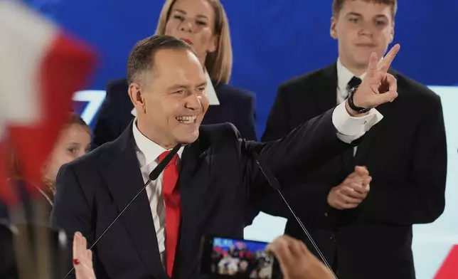 FILE - Presidential candidate Karol Nawrocki, a conservative historian backed by the right-wing Law and Justice party greets supporters as he arrives at his headquarters after the presidential election runoff in Warsaw, Poland, Sunday, June 1, 2025. (AP Photo/Czarek Sokolowski, File)