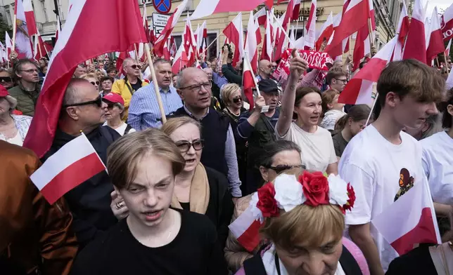 FILE - Supporters of conservative presidential candidate Karol Nawrocki take part in a march one week ahead of a decisive election in Warsaw Poland, Sunday, May 25, 2025. (AP Photo/Czarek Sokolowski, File)