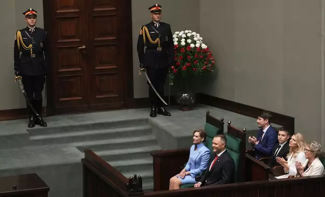 Poland's new president Karol Nawrocki with his wife Marta Nawrocka attends his inauguration ceremony in Warsaw, Poland, Wednesday, Aug. 6, 2025. (AP Photo/Czarek Sokolowski)