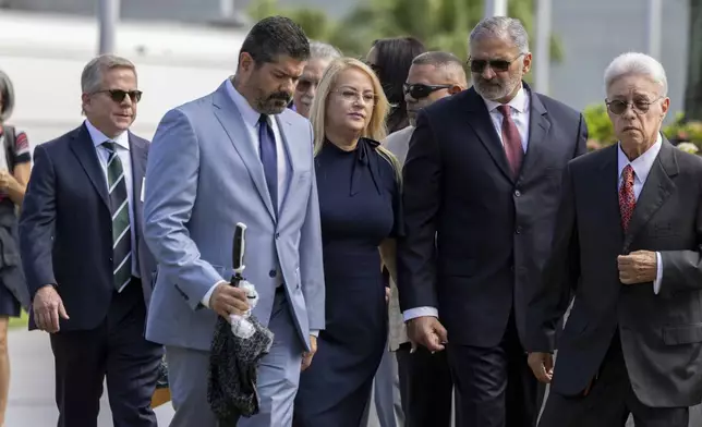 Former Puerto Rico Gov. Wanda Vázquez, center, leaves the federal courthouse with her legal team in San Juan, Puerto Rico, Wednesday, Aug. 27, 2025. (AP Photo/Alejandro Granadillo)