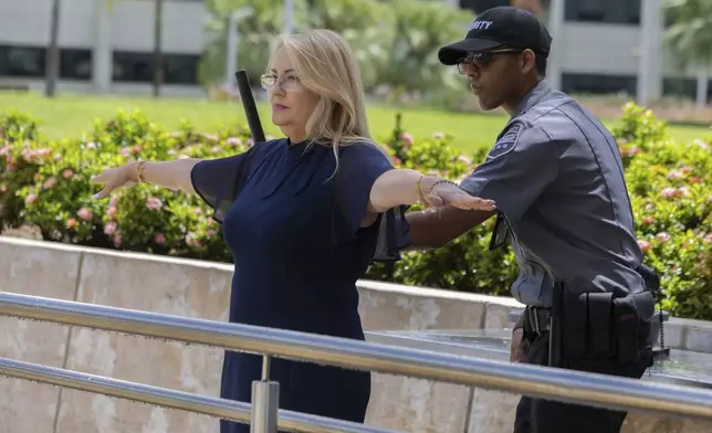 Former Puerto Rico Gov. Wanda Vázquez undergoes a security screening as she enters the federal courthouse in San Juan, Puerto Rico, Wednesday, Aug. 27, 2025. (AP Photo/Alejandro Granadillo)