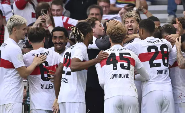 Stuttgart's players celebrate the opening goal during the German Bundesliga soccer match between VfB Stuttgart and Borussia Moenchengladbach in Stuttgart, Germany, Saturday, Aug. 30, 2025. (Marijan Murat/dpa via AP)