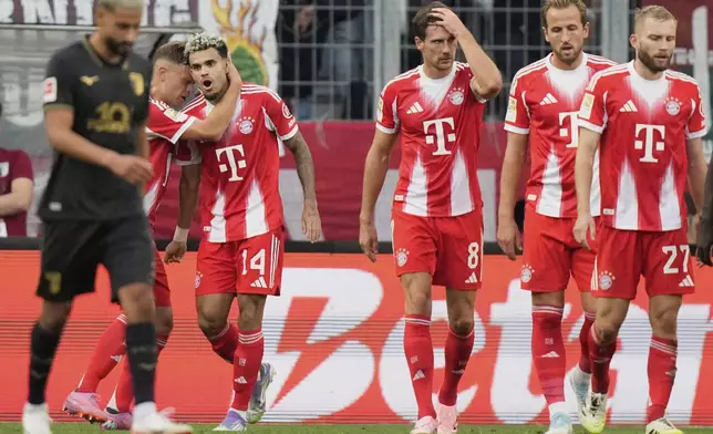 Bayern's Luis Diaz, second left, celebrates after scoring his side's second goal during the Bundesliga soccer match between FC Augsburg and FC Bayern Munich in Augsburg, Germany, Aug. 30, 2025. (AP Photo/Matthias Schrader)