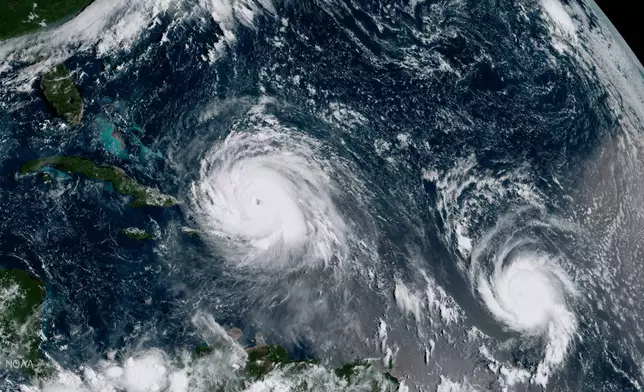 FILE - This Thursday, Sept. 7, 2017 satellite image made available by NOAA shows the eye of Hurricane Irma, left, just north of the island of Hispaniola, with Hurricane Jose, right, in the Atlantic Ocean. (NOAA via AP,File)