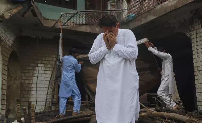 A local resident reacts after looking at his damaged home following Friday's flash flooding at Pishoreen village in Buner district, in Pakistan's northwest, Sunday, Aug. 17, 2025. (AP Photo/Muhammad Sajjad)