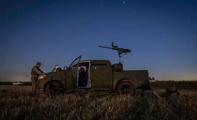 Ukrainian servicemen of the 15th Army Corps stand by an armed pickup truck during night duty in the Chernihiv region, Ukraine, late Tuesday, Aug. 12, 2025. (AP Photo/Dan Bashakov)