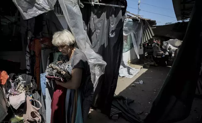 FILE - In this photo provided by Ukraine's 24th Mechanized Brigade press service, a vendor leaves a market attacked by a Russian drone in the town of Druzhkivka, Donetsk region, Ukraine, Saturday, Aug. 2, 2025, (Oleg Petrasiuk/Ukraine's 24th Mechanized Brigade via AP, File)