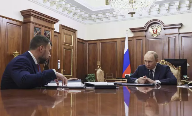 FILE - Russian President Vladimir Putin, right, speaks with the head of the Russian-controlled Donetsk region, Denis Pushilin, at the Kremlin in Moscow, Russia, Monday, Aug. 4, 2025. (Mikhail Metzel, Sputnik, Kremlin Pool Photo via AP, File)