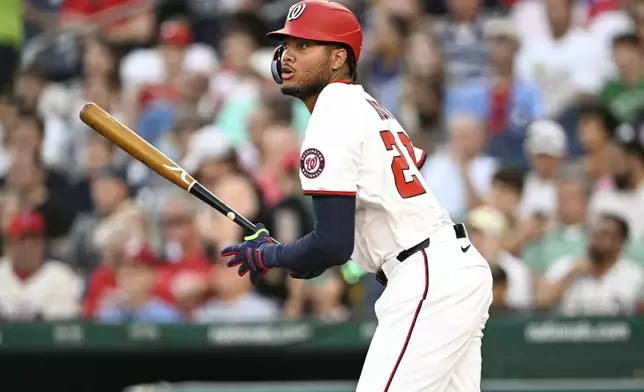 Washington Nationals' James Wood watches his single hit off Philadelphia Phillies pitcher Jesús Luzardo during the third inning of a baseball game, Thursday, Aug. 14, 2025, in Washington. (AP Photo/Terrance Williams)