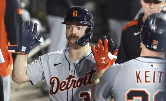 Detroit Tigers catcher Jake Rogers (34) celebrates a three run home run during the ninth inning against the Chicago White Sox in a baseball game, Tuesday, Aug. 12, 2025, in Chicago. (AP Photo/Talia Sprague)