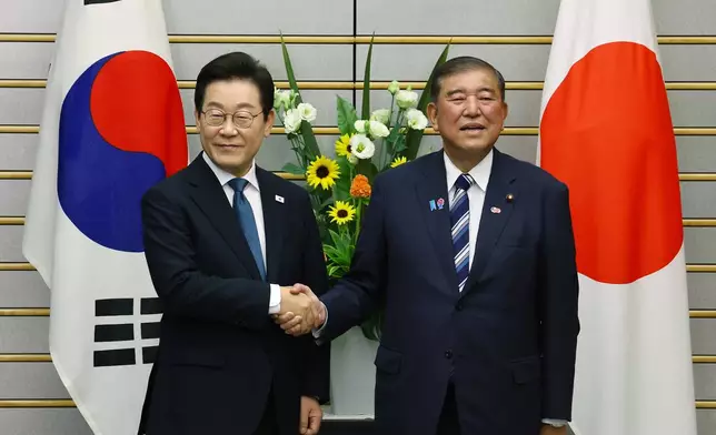 South Korean President Lee Jae Myung, left, meets Japan's Prime Minister Shigeru Ishiba in Tokyo, Saturday, Aug. 23, 2025. (Kim Kyung-Hoon/Pool Photo via AP)
