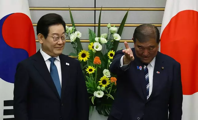 South Korean President Lee Jae Myung, left, meets Japan's Prime Minister Shigeru Ishiba in Tokyo, Saturday, Aug. 23, 2025. (Kim Kyung-Hoon/Pool Photo via AP)