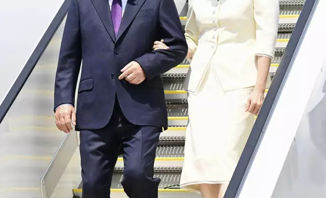 South Korean President Lee Jae Myung, left, and his wife Kim Hea Kyung, right, arrive at the Haneda airport in Tokyo, Japan, Saturday, Aug. 23, 2025. (Kyodo News via AP)