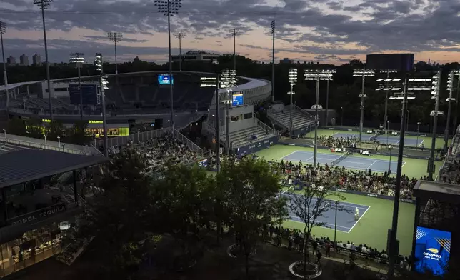 Shielded LED lights shine over the tennis courts during the U.S. Open tennis championships at the USTA Billie Jean King National Tennis Center, Tuesday, Aug. 19, 2025, in New York. (AP Photo/Yuki Iwamura)