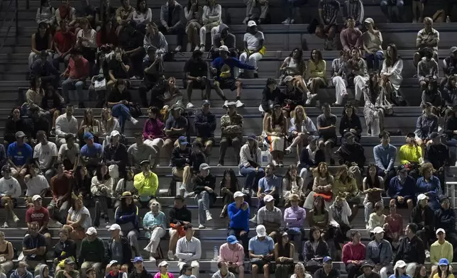 People watch a tennis match during the U.S. Open tennis championships at the USTA Billie Jean King National Tennis Center, Tuesday, Aug. 19, 2025, in New York. (AP Photo/Yuki Iwamura)