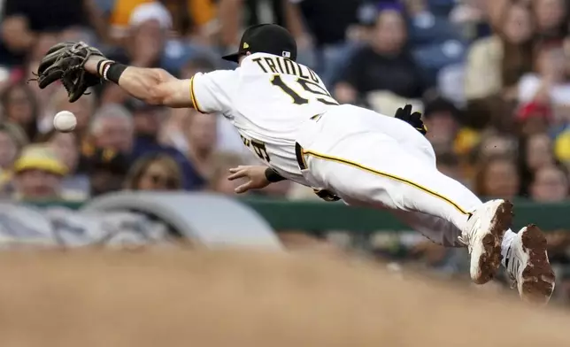 Pittsburgh Pirates third baseman Jared Triolo reaches for but cannot field a double hit by Cincinnati Reds' Noelvi Marte during the fourth inning of a baseball game, Saturday, Aug. 9, 2025, in Pittsburgh. (AP Photo/Matt Freed)