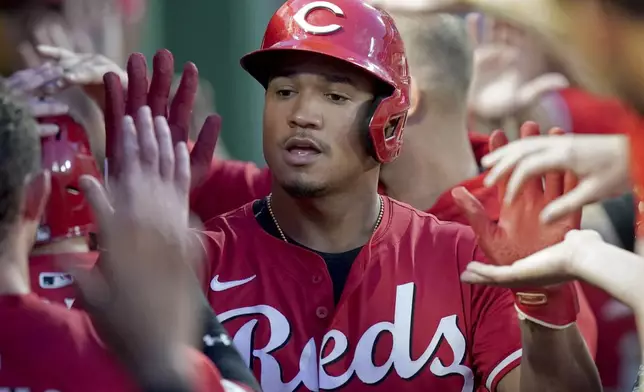 Cincinnati Reds' Noelvi Marte celebrates in the dugout after scoring during the seventh inning of a baseball game against the Pittsburgh Pirates, Saturday, Aug. 9, 2025, in Pittsburgh. (AP Photo/Matt Freed)