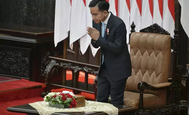 Indonesian Vice President Gibran Rakabuming Raka gestures before President Prabowo Subianto delivers his annual State of the Nation Address, ahead of the country's Independence Day in Jakarta Friday, Aug. 15, 2025. (Bay Ismoyo/Pool Photo via AP)