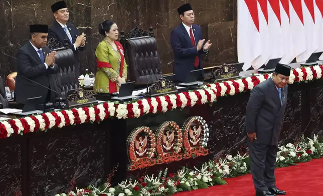Indonesian President Prabowo Subianto, bottom right, bows in front of parliament members before he delivers his annual State of the Nation Address, ahead of the country's Independence Day, in Jakarta, Indonesia Friday, Aug. 15, 2025. (Ajeng Dinar Ulfiana/Pool Photo via AP)