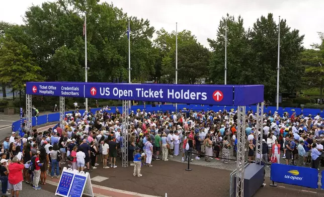Spectators wait for gates to open at the Billie Jean King National Tennis Center for the first round of the US Open tennis championships, Sunday, Aug. 24, 2025, in New York. (AP Photo/Yuki Iwamura)