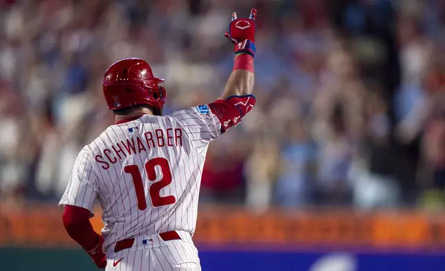 Philadelphia Phillies' Kyle Schwarber reacts to his solo home run during the eighth inning of a baseball game against the Detroit Tigers, Sunday, Aug. 3, 2025, in Philadelphia. (AP Photo/Chris Szagola)