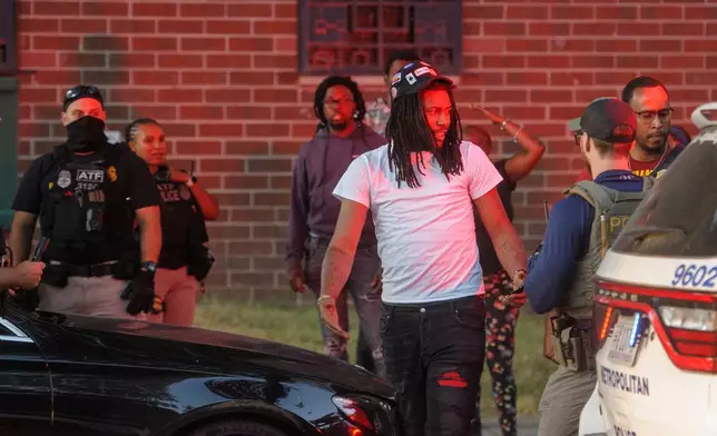 A man has his car searched by multiple federal agencies including Department of Homeland Security investigations, Bureau of Alcohol, Tobacco, Firearms and Explosives (ATF) and the Washington Metro Police Department in Washington, Monday, Aug. 25, 2025. (AP Photo/Rod Lamkey, Jr.)