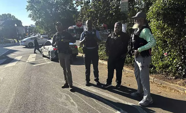 Officers from the Washington Metro Police and the Bureau of Alcohol, Tobacco, Firearms and Explosives (ATF) are seen in the Mount Pleasant neighborhood in Washington as arrests are made at a nearby apartment building, Wednesday, Aug. 27, 2025. (AP Photo/Collin Binkley)