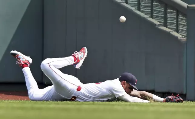 Boston Red Sox centerfielder Ceddanne Rafaela can't make the catch on a first inning double hit by the Houston Astros' Jesus Sanchez during a baseball game, Sunday, Aug. 3, 2025, in Boston. (AP Photo/Jim Davis)