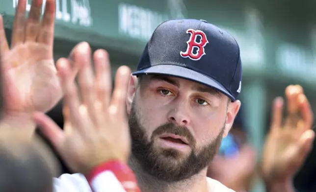 Boston Red Sox starting pitcher Lucas Giolito gets high fives in the dugout after the top of the eighth inning during a baseball game against the Houton Astros, Sunday, August 3, 2025, in Boston (AP Photo/Jim Davis).