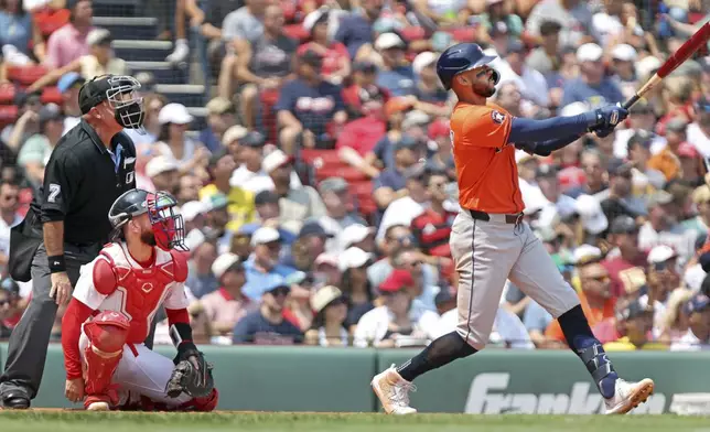Houston Astros batter Carlos Correa hits a home run in the fourth inning of a baseball game against the Boston Red Sox, Sunday, Aug. 3, 2025, in Boston (AP Photo/Jim Davis)