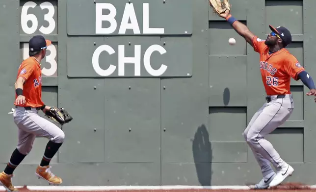 Houston Astros center fielder Taylor Trammell, right, can't make the catch on a fourth inning double hit by Boston Red Sox's Roman Anthony, not pictured, during a baseball game, Sunday, Aug. 3, 2025, in Boston. Astros left fielder Mauricio Dubonn is at left. (AP Photo/Jim Davis)