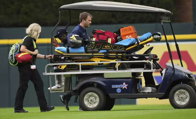 Houston Astros center fielder Taylor Trammell is transported off the field on a medical cart after being injured attempting to catch a Detroit Tigers' Dillon Dingler fly ball in the first inning during a baseball game Wednesday, Aug. 20, 2025, in Detroit. (AP Photo/Paul Sancya)