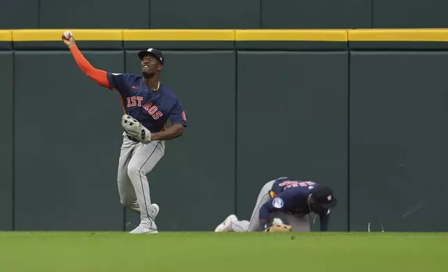 Houston Astros left fielder Jesús Sánchez throws the ball in as center fielder Taylor Trammell is injured attempting to catch a Detroit Tigers' Dillon Dingler fly ball in the first inning during a baseball game Wednesday, Aug. 20, 2025, in Detroit. (AP Photo/Paul Sancya)