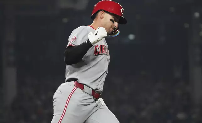 Cincinnati Reds' Spencer Steer celebrates as he rounds the bases after hitting a three-run home run during the seventh inning of a baseball game against the Chicago Cubs in Chicago, Tuesday, Aug. 5, 2025. (AP Photo/Nam Y. Huh)