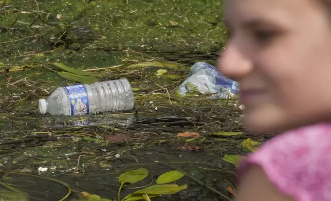 Dumped plastic garbages on the Seine river near Eiffel Tower in Paris, France, Wednesday, Aug. 6, 2025. (AP Photo/Michel Euler)