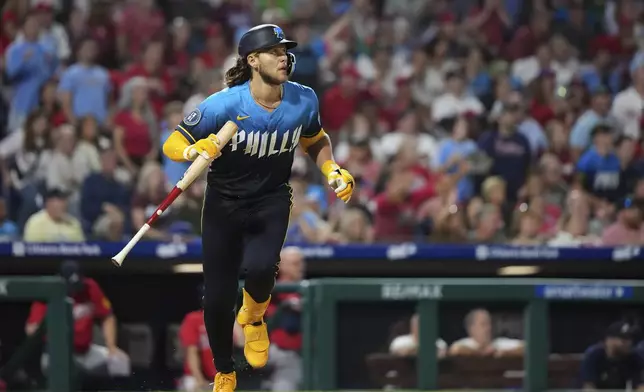 Philadelphia Phillies' Alec Bohm watches after hitting an RBI-sacrifice fly against Atlanta Braves pitcher Pierce Johnson during the eighth inning of a baseball game Friday, Aug. 29, 2025, in Philadelphia. (AP Photo/Matt Slocum)