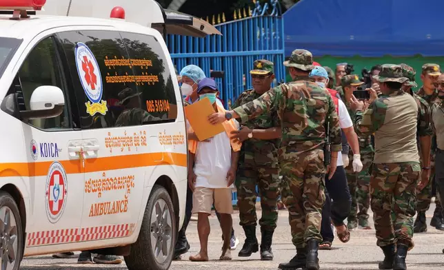 In this photo released by Agence Kampuchea Press (AKP), a Cambodian soldier, second from left, enters an ambulance at O Smach, Cambodian-Thai border in Oddar Meanchey province, Cambodia, Friday, Aug. 1, 2025. (AKP via AP)