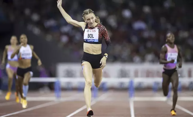 Femke Bol of the Netherlands crosses the finish line winning the women's 400m hurdles competition during the World Athletics Diamond League final 2025 athletics meeting in Zurich, Switzerland, Thursday, Aug. 28, 2025. (Michael Buholzer/Keystone via AP)