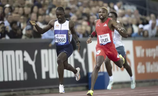 Noah Lyles of United States, right, crosses the finish line ahead of Botswana's Letsile Tebogo to win the men's 200-meter race at the World Athletics Diamond League final 2025 athletics meeting in Zurich, Switzerland, Thursday, Aug. 28, 2025. (Til Buergy/Keystone via AP)