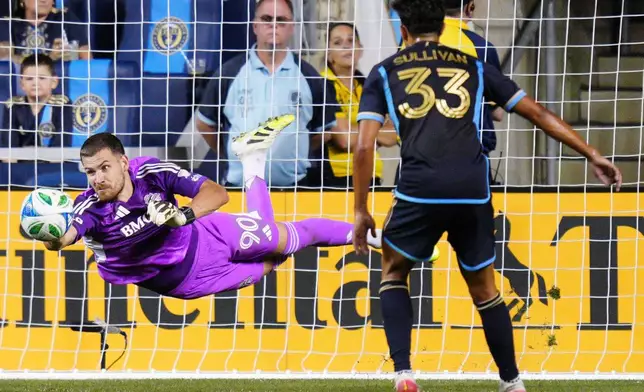 Toronto FC goalkeeper Luka Gavran (90) makes a diving save during the second half of an MLS soccer match against the Philadelphia Union, Saturday, Aug. 9, 2025, in Chester, Pa. (AP Photo/Derik Hamilton)