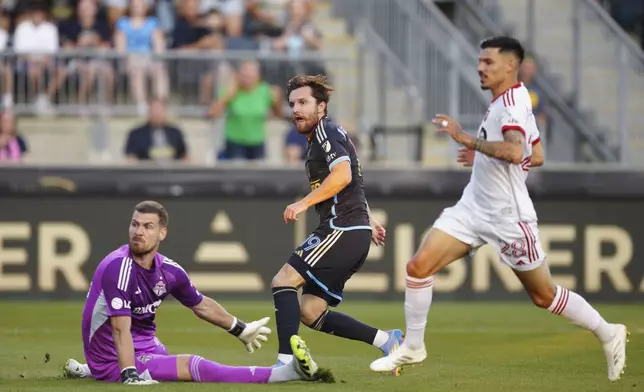 Philadelphia Union's Indiana Vassilev, center, watches his goal past Toronto FC goalkeeper Luka Gavran, left, and Raoul Petretta, right, during the first half of an MLS soccer match, Saturday, Aug. 9, 2025, in Chester, Pa. (AP Photo/Derik Hamilton)