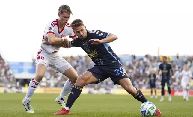 Philadelphia Union's Bruno Damiani, right, and Toronto FC's Sigurd Rosted, left, battle for position during the first half of an MLS soccer match, Saturday, Aug. 9, 2025, in Chester, Pa. (AP Photo/Derik Hamilton)