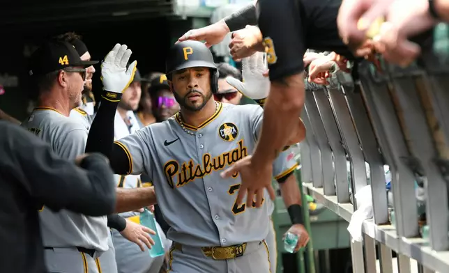 Pittsburgh Pirates Tommy Pham celebrates with teammates in the dugout after hitting a solo home run during the fourth inning of a baseball game against the Chicago Cubs, Saturday, Aug. 16, 2025, in Chicago. (AP Photo/Paul Beaty)