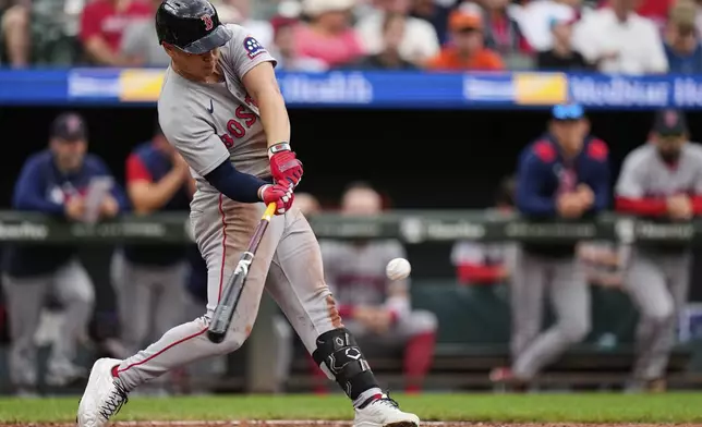 Boston Red Sox designated hitter Rob Refsnyder hits a home run during the fourth inning of a baseball game against the Baltimore Orioles, Thursday, Aug. 28, 2025, in Baltimore. (AP Photo/Stephanie Scarbrough)
