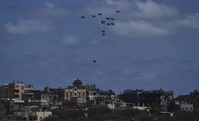 Humanitarian aid is airdropped to Palestinians over Nuseirat, central Gaza Strip, Thursday, Aug. 7, 2025. (AP Photo/Abdel Kareem Hana)