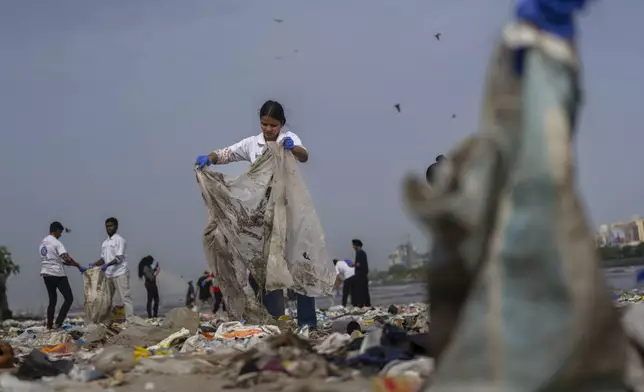 FILE - Volunteers clean up plastic and other waste materials on a beach on the Arabian Sea coast on World Environment Day in Mumbai, India, June 5, 2025. (AP Photo/Rafiq Maqbool, File)