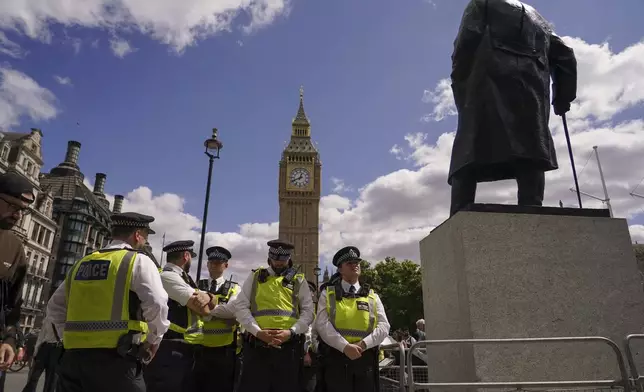 Police officers line up before a demonstration in support of the Palestinian People in Gaza, in Parliament Square, in London, Saturday, Aug. 9, 2025.(AP Photo/Alberto Pezzali)
